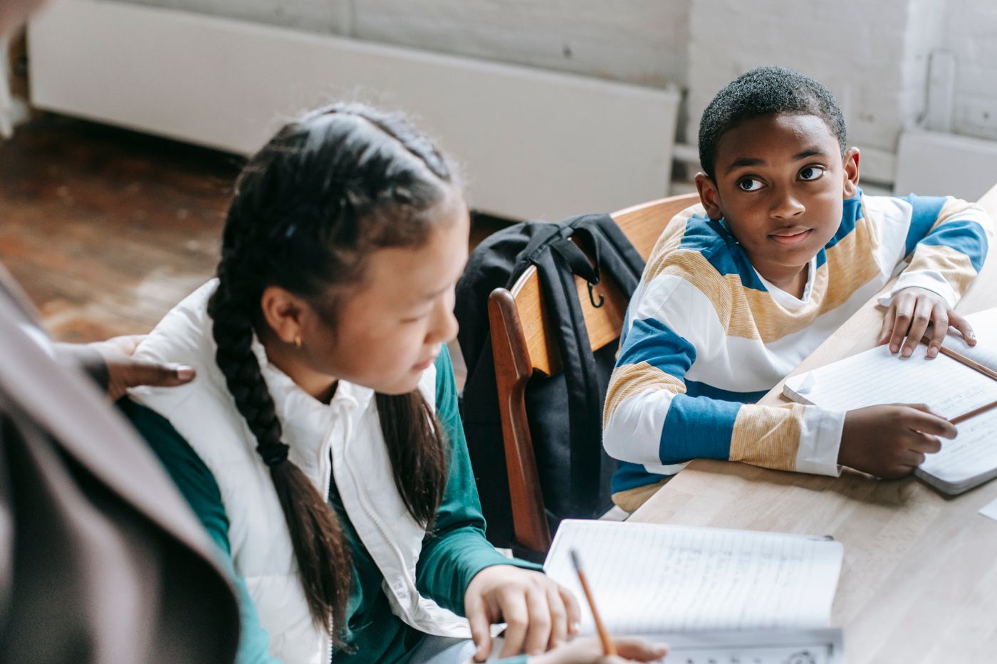 Students and a teacher working together at a classroom table