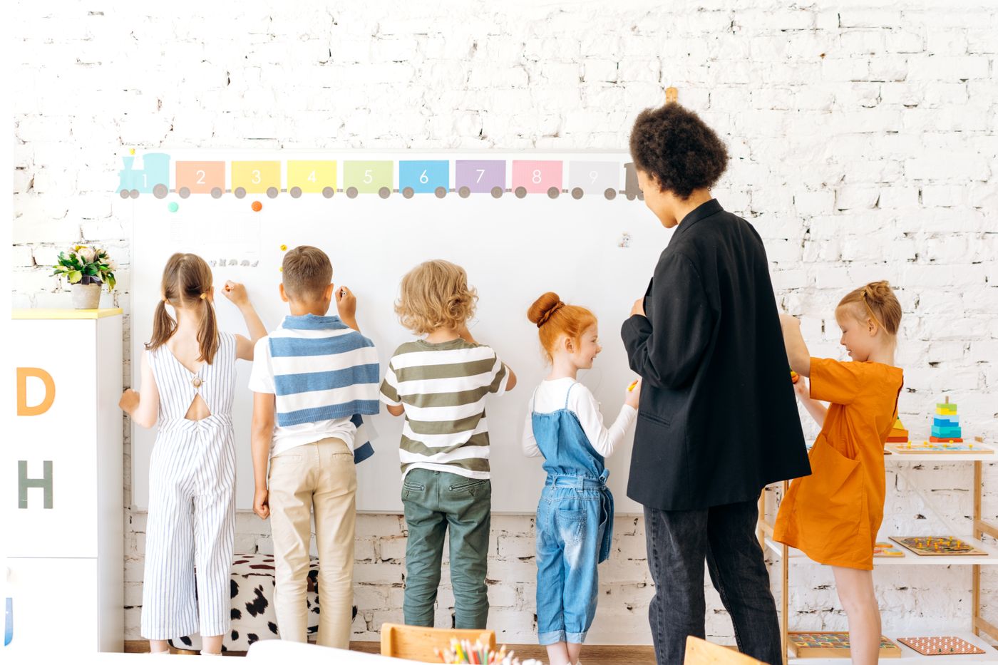 Children creating and learning at a classroom whiteboard